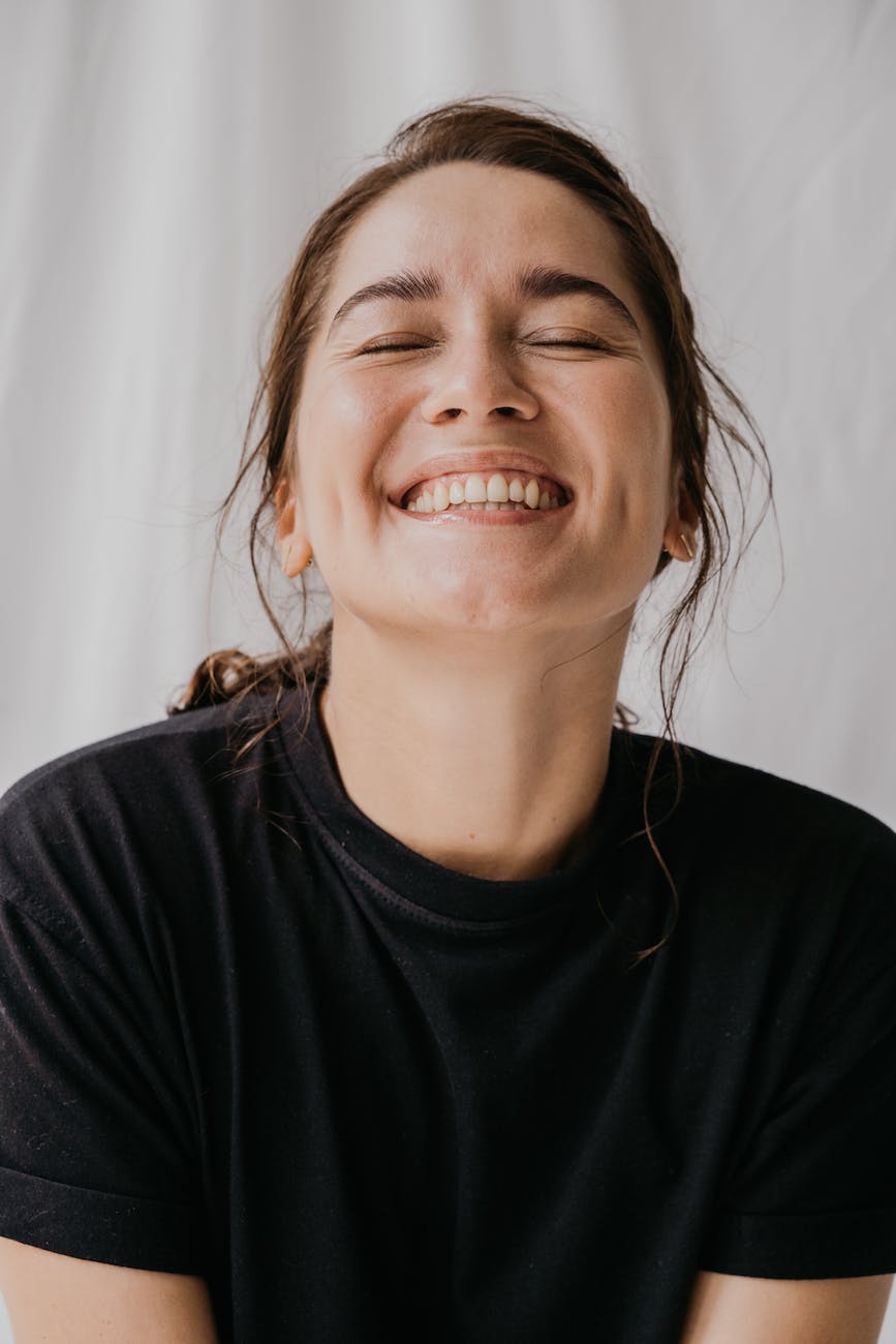 woman eyes closed while smiling