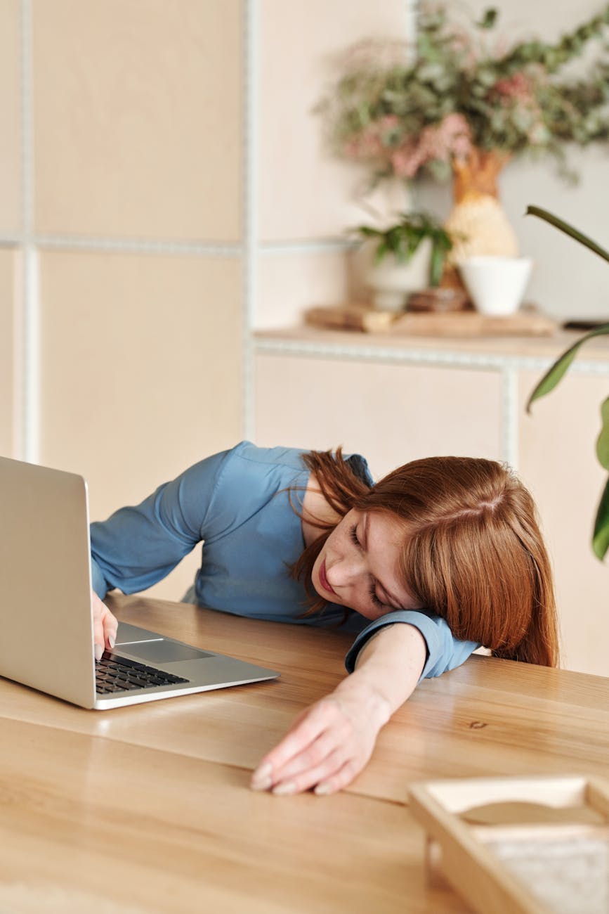 exhausted woman working with laptop
